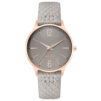 Nine West Damen Analog Quarzuhr mit silberfarbenem Metallgehäuse und Metallarmband, rosa Zifferblatt