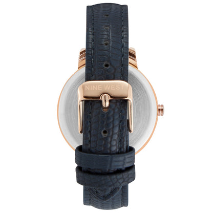 Nine West Damen Analog Quarzuhr mit roséfarbenem Metallgehäuse und Metallarmband, dunkelblaues Zifferblatt